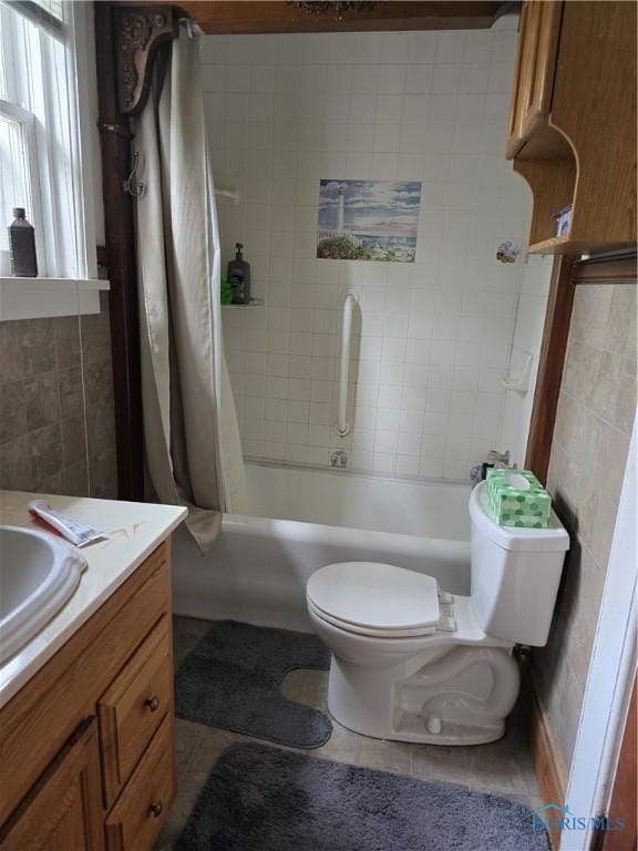 336 Holgate Ave, Defiance, OH 43512 - full bathroom featuring vanity, shower / bath combo, tile patterned flooring, and tile walls
