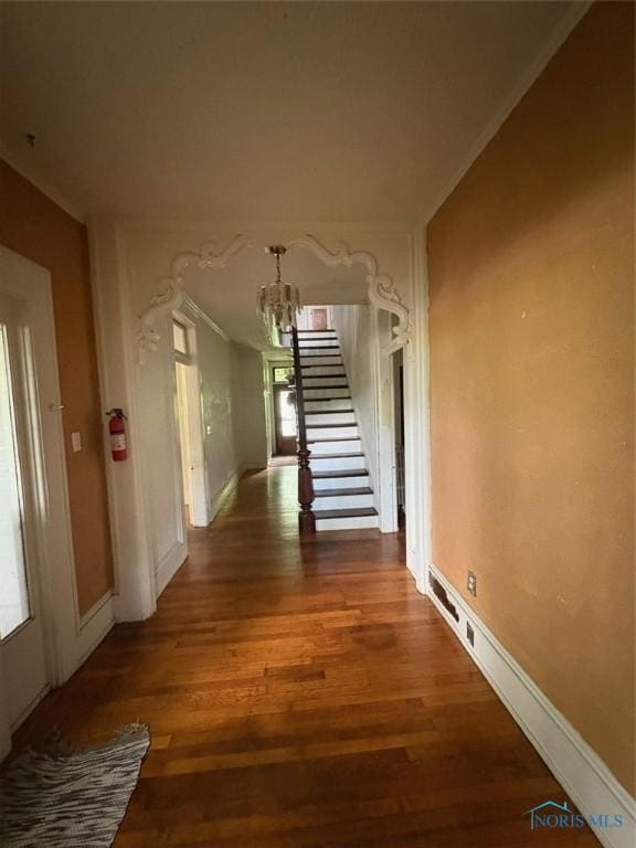 336 Holgate Ave, Defiance, OH 43512 - corridor featuring a chandelier, stairs, wood finished floors, and ornamental molding