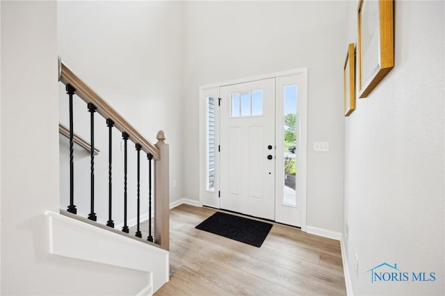 160 Bentley Dr, Perrysburg, OH 43551 - entrance foyer with wood finished floors, stairs, baseboards, and a high ceiling
