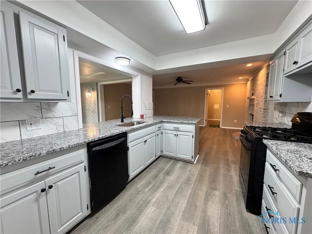 2102 Glen Arbor Dr, Toledo, OH 43614 - kitchen featuring black appliances, backsplash, light wood finished floors, light stone counters, and a sink
