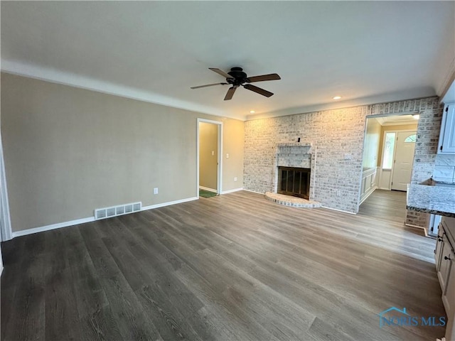 2102 Glen Arbor Dr, Toledo, OH 43614 - unfurnished living room featuring ceiling fan, baseboards, dark wood finished floors, and a fireplace