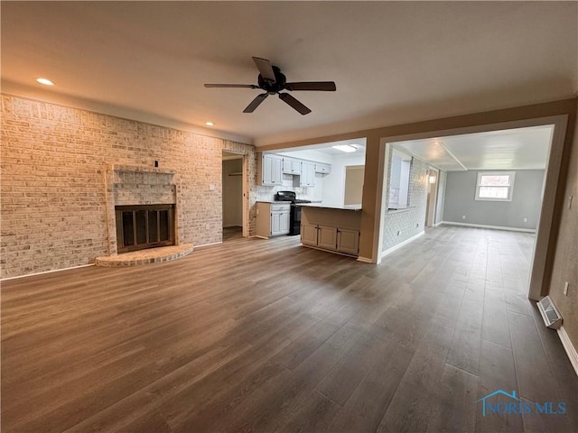 2102 Glen Arbor Dr, Toledo, OH 43614 - unfurnished living room with baseboards, a ceiling fan, a brick fireplace, dark wood-type flooring, and brick wall
