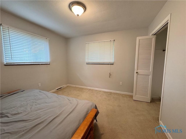 2102 Glen Arbor Dr, Toledo, OH 43614 - bedroom featuring light colored carpet, baseboards, and a textured ceiling