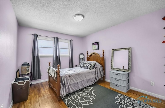 864 Maple Ln, Waterville, OH 43566 - bedroom featuring wood finished floors and a textured ceiling