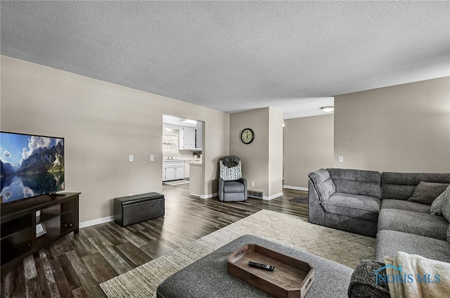 864 Maple Ln, Waterville, OH 43566 - living area with dark wood-type flooring and a textured ceiling