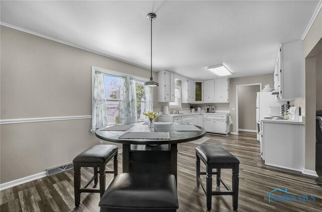 864 Maple Ln, Waterville, OH 43566 - dining area with dark wood-style flooring