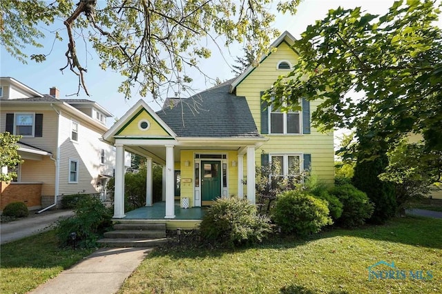 117 3rd St, Findlay, OH 45840 - view of front of property featuring covered porch, a front yard, and roof with shingles