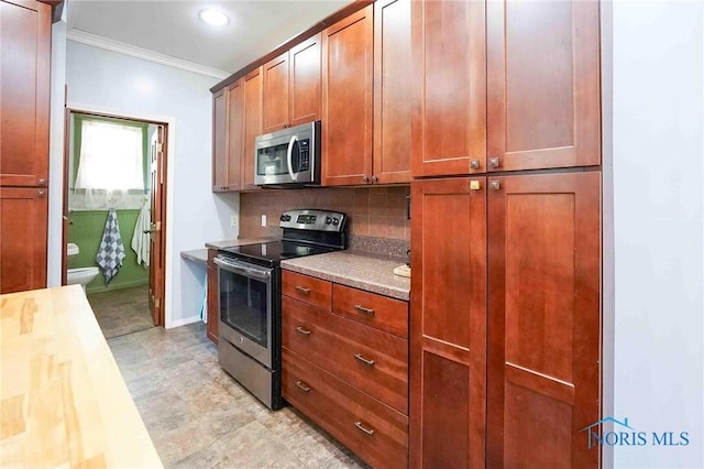 117 3rd St, Findlay, OH 45840 - kitchen with stainless steel appliances, decorative backsplash, crown molding, baseboards, and brown cabinets