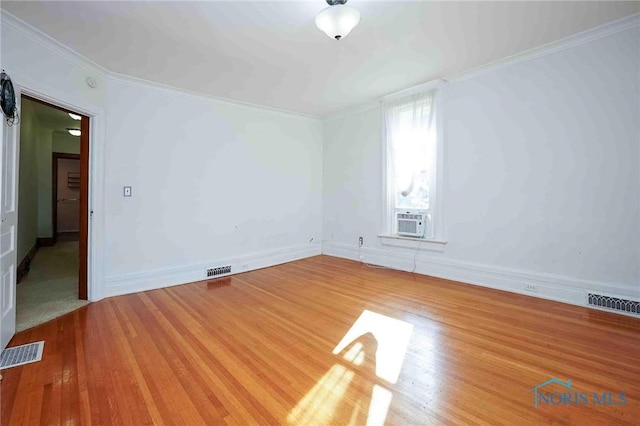 117 3rd St, Findlay, OH 45840 - unfurnished room featuring wood finished floors, ornamental molding, cooling unit, and baseboards