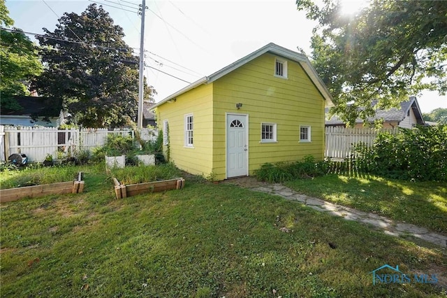 117 3rd St, Findlay, OH 45840 - rear view of house featuring a vegetable garden