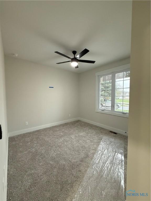 670 Rdg Lake Ct, Perrysburg, OH 43551 - empty room featuring carpet floors, baseboards, a ceiling fan, and a smoke detector