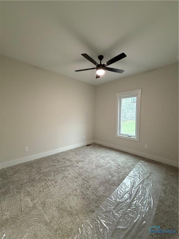 670 Rdg Lake Ct, Perrysburg, OH 43551 - empty room featuring carpet, ceiling fan, and baseboards