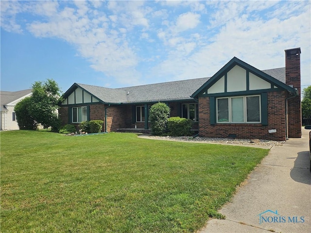 110 Harbor Point Rd, Rossford, OH 43460 - english style home featuring brick siding, a front yard, a chimney, and roof with shingles