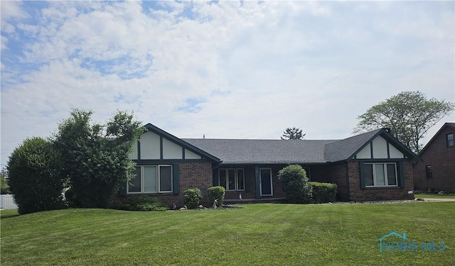 110 Harbor Point Rd, Rossford, OH 43460 - tudor-style house featuring a front yard and brick siding