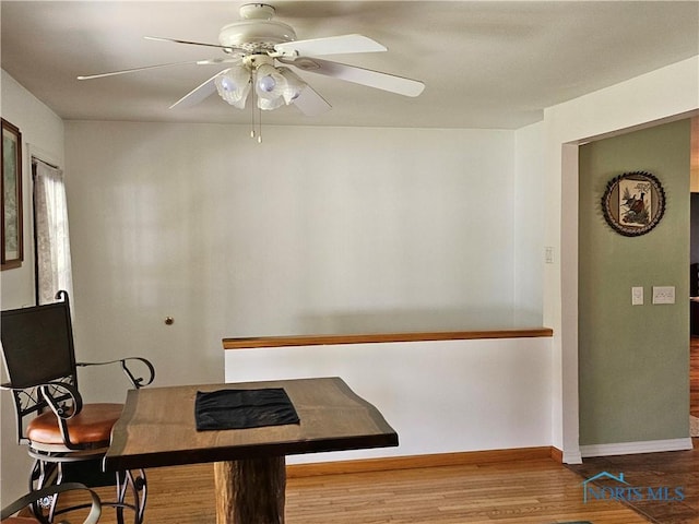 110 Harbor Point Rd, Rossford, OH 43460 - dining area with wood finished floors, a ceiling fan, and baseboards