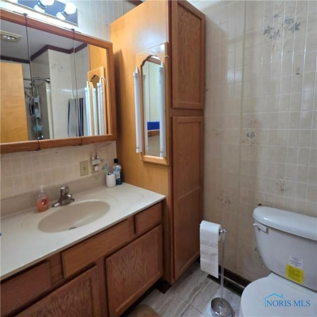 1154 Lagrange St, Napoleon, OH 43545 - bathroom featuring vanity, tile walls, and decorative backsplash
