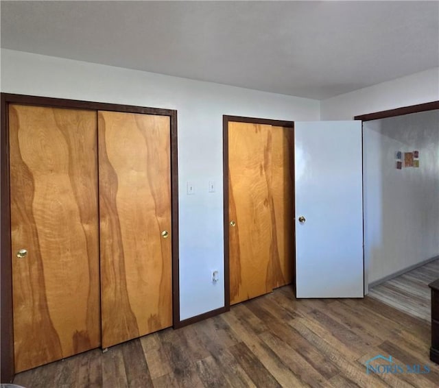 1154 Lagrange St, Napoleon, OH 43545 - unfurnished bedroom with multiple closets and wood finished floors