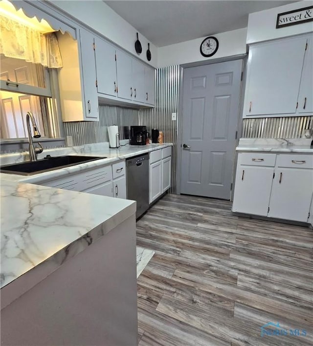1154 Lagrange St, Napoleon, OH 43545 - kitchen featuring dishwasher, a sink, light countertops, and wood finished floors