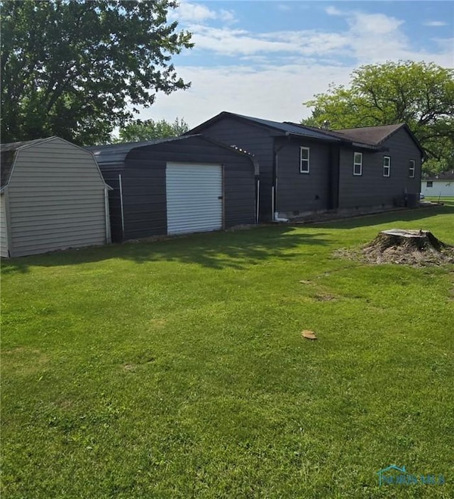 1154 Lagrange St, Napoleon, OH 43545 - back of house with a yard and an outdoor structure
