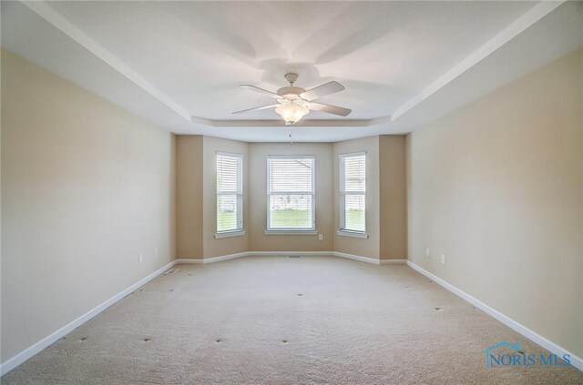 8971 N Park Lake Cir, Sylvania, OH 43560 - carpeted empty room with a tray ceiling and a ceiling fan
