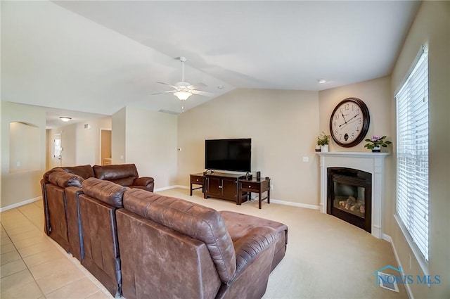 8971 N Park Lake Cir, Sylvania, OH 43560 - living room with ceiling fan, a glass covered fireplace, lofted ceiling, and plenty of natural light