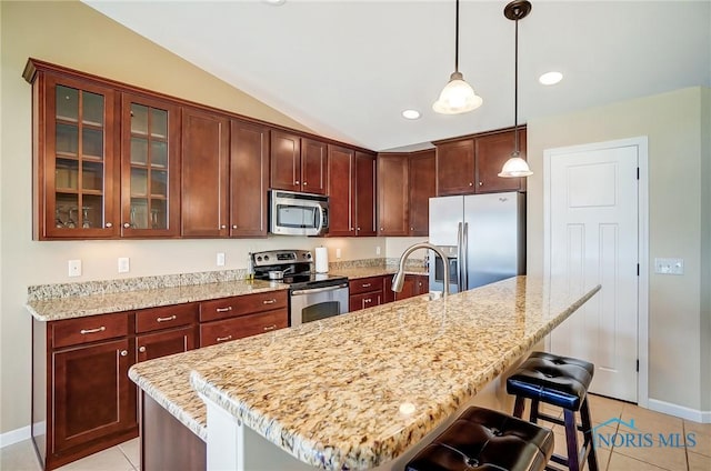 8971 N Park Lake Cir, Sylvania, OH 43560 - kitchen with appliances with stainless steel finishes, light tile patterned floors, vaulted ceiling, a kitchen breakfast bar, and glass insert cabinets
