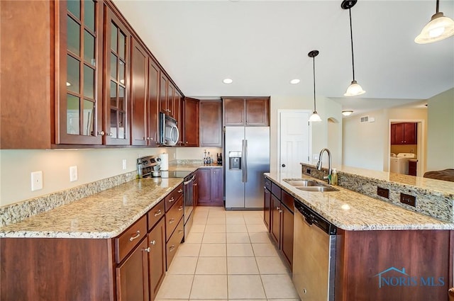 8971 N Park Lake Cir, Sylvania, OH 43560 - kitchen featuring stainless steel appliances, independent washer and dryer, light tile patterned floors, decorative light fixtures, and recessed lighting