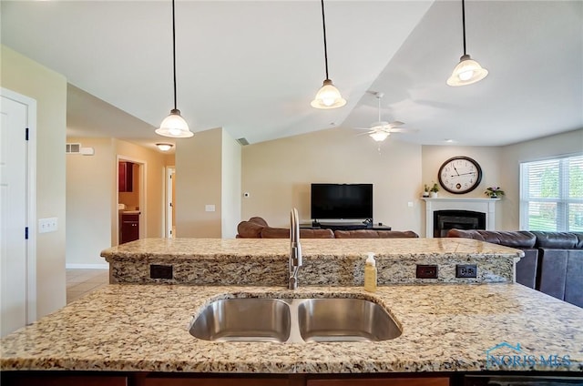 8971 N Park Lake Cir, Sylvania, OH 43560 - kitchen featuring ceiling fan, open floor plan, light stone counters, vaulted ceiling, and decorative light fixtures