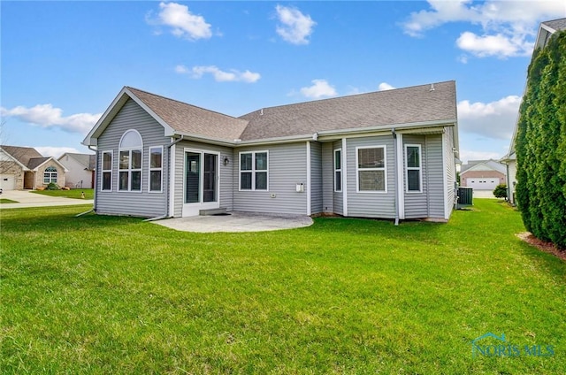 8971 N Park Lake Cir, Sylvania, OH 43560 - back of house with roof with shingles, a patio, and a lawn
