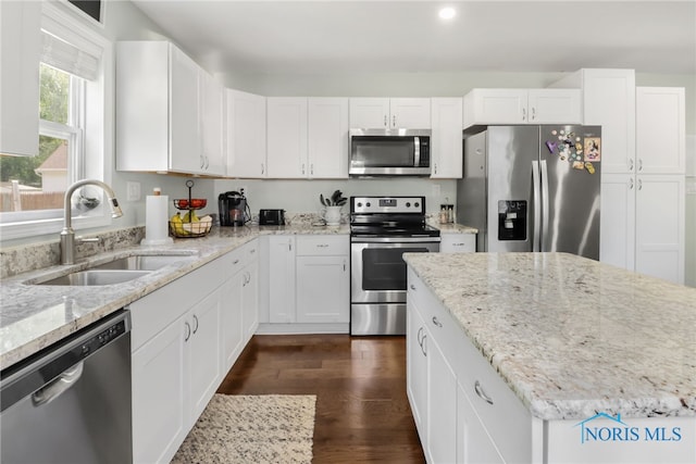 6564 Blossman Rd, Toledo, OH 43617 - kitchen with appliances with stainless steel finishes, white cabinets, light stone counters, and recessed lighting