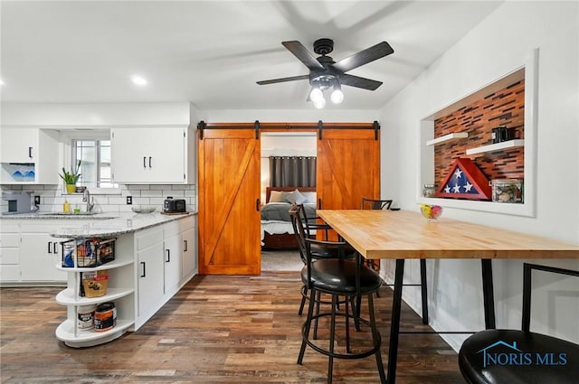 3118 Keemont Dr, Toledo, OH 43613 - kitchen featuring a barn door, open shelves, dark wood finished floors, a ceiling fan, and white cabinetry