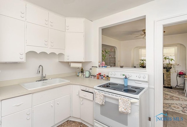 4405 Vermaas Ave, Toledo, OH 43612 - kitchen with electric range, light countertops, white cabinets, and ceiling fan