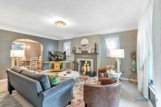 3643 Kershaw Ave, Toledo, OH 43613 - living area with arched walkways, baseboards, a fireplace, and crown molding