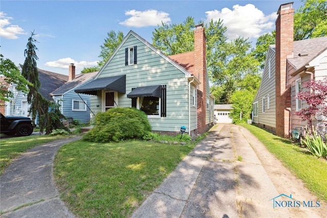 3643 Kershaw Ave, Toledo, OH 43613 - bungalow-style house with a front lawn and a chimney