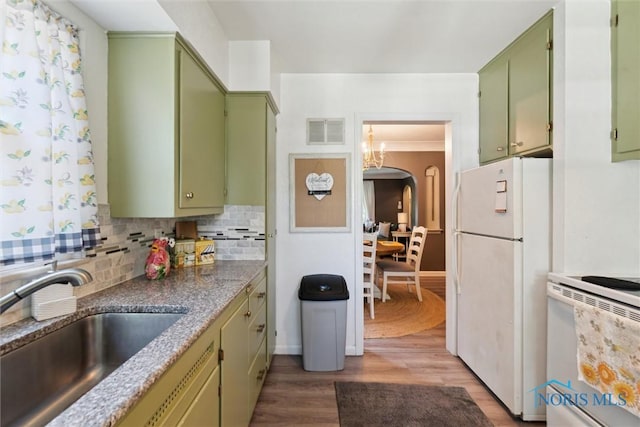 3643 Kershaw Ave, Toledo, OH 43613 - kitchen featuring green cabinetry, white appliances, wood finished floors, a chandelier, and tasteful backsplash