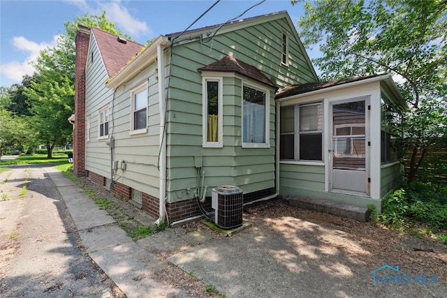 3643 Kershaw Ave, Toledo, OH 43613 - view of side of home featuring a cooling unit and a chimney