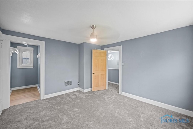 726 Spring Grove Ave, Toledo, OH 43605 - unfurnished bedroom with carpet flooring, baseboards, and ceiling fan
