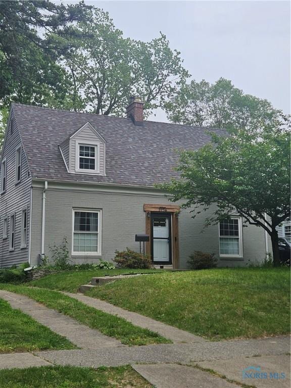 2728 Goddard Rd, Toledo, OH 43606 - view of front of property featuring a chimney and a front lawn