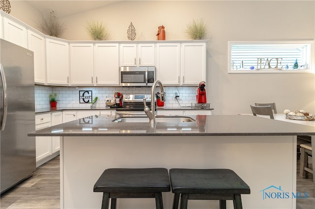 1948 Sunrise Creek Dr, Toledo, OH 43615 - kitchen featuring appliances with stainless steel finishes, a sink, tasteful backsplash, and a breakfast bar