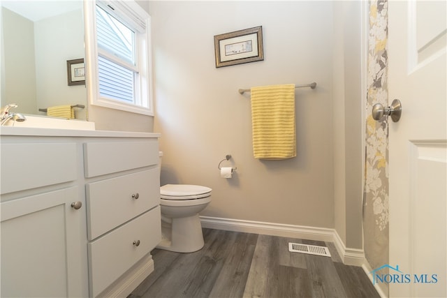 1948 Sunrise Creek Dr, Toledo, OH 43615 - bathroom with vanity, toilet, wood finished floors, and baseboards