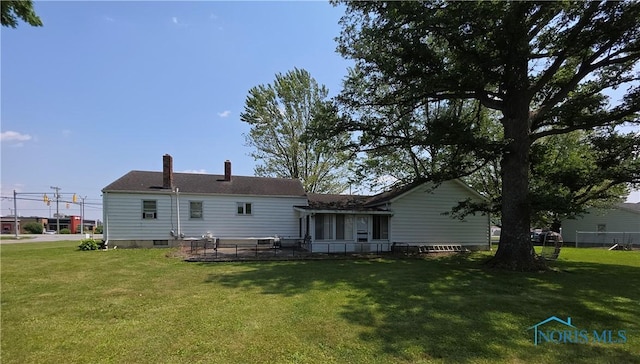 1649 N Perry St, Ottawa, OH 45875 - back of house featuring a yard, a chimney, and a patio area