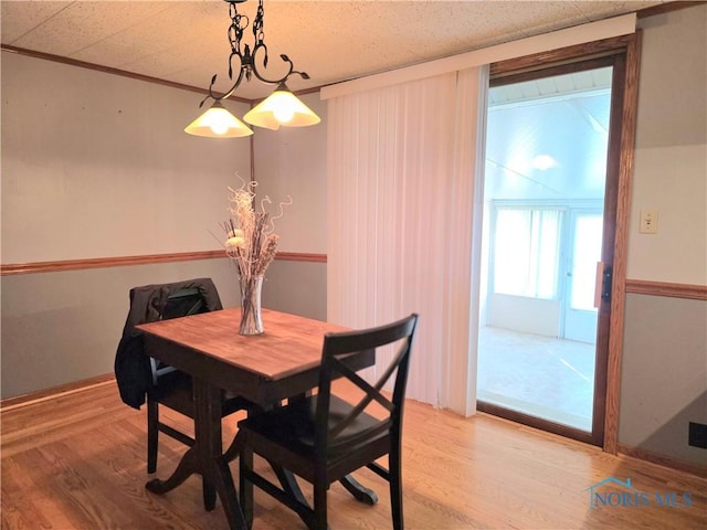 1649 N Perry St, Ottawa, OH 45875 - dining space featuring light wood-style floors and crown molding
