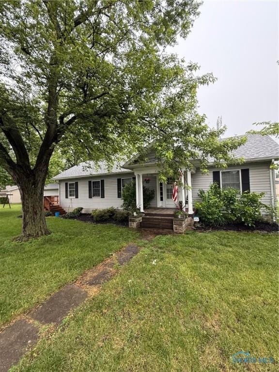 7102 Hall St, Holland, OH 43528 - view of front of home featuring covered porch and a front lawn