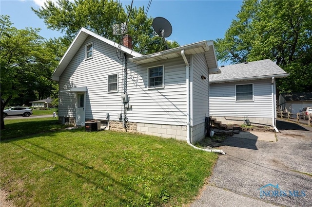 7102 Hall St, Holland, OH 43528 - view of property exterior featuring a yard, a chimney, and cooling unit