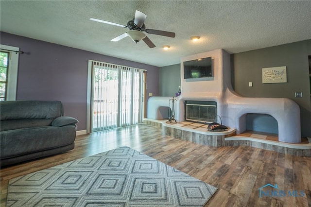 7102 Hall St, Holland, OH 43528 - living area featuring wood finished floors, plenty of natural light, a textured ceiling, ceiling fan, and baseboards