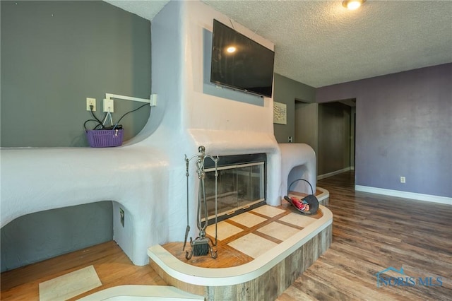 7102 Hall St, Holland, OH 43528 - living room featuring a textured ceiling, wood finished floors, and baseboards