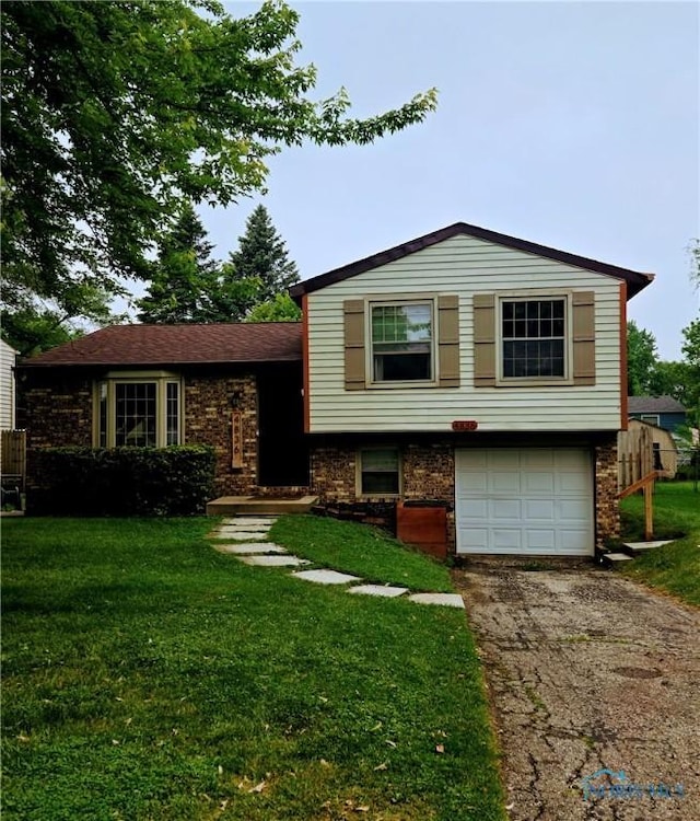 4836 Catalina Dr, Toledo, OH 43615 - tri-level home featuring asphalt driveway, an attached garage, and brick siding