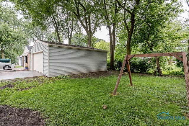 716 Maple St, Perrysburg, OH 43551 - view of grassy yard with an outbuilding, driveway, and an attached garage