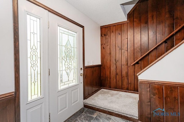716 Maple St, Perrysburg, OH 43551 - foyer with wooden walls, wainscoting, and a textured ceiling