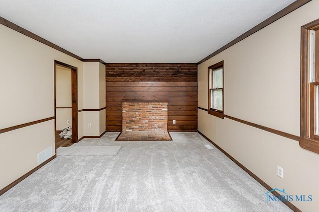 716 Maple St, Perrysburg, OH 43551 - unfurnished living room with wood walls, carpet, and ornamental molding